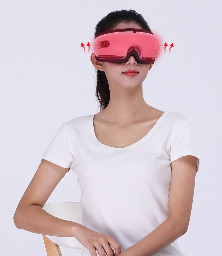 Woman wearing heated eye massager for relaxation